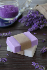 Obraz na płótnie Canvas Natural handmade soap bars with lavender on rustic wooden background. Natural soap bars with essential oils and medicinal plants extracts. SPA concept. Side view.
