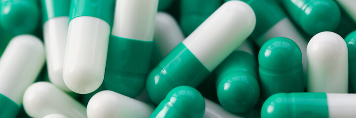 Lots of medical white green pills and vitamins. Development of the concept of the pharmaceutical...
