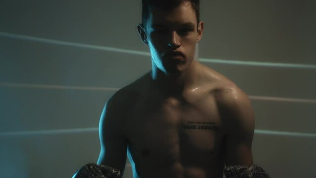 Boxer Putting On Mouth Guard Before The Game Starts. - close up