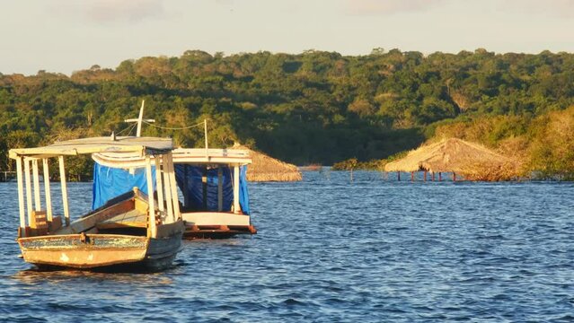 Boats moored in the waters near the city of Santar&eacute;m at sunset , State of Par&aacute;, Brazil. Handheld shot
