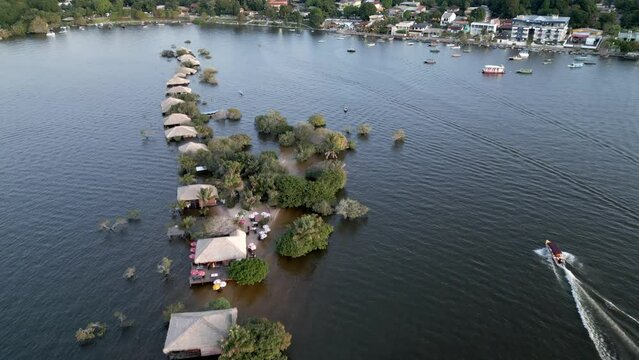 Aerial over the flooded buildings near Love Island (Ilha do Amor) during the rainy season in the State of Par&aacute;, Brazil. Drone dolly forward shot