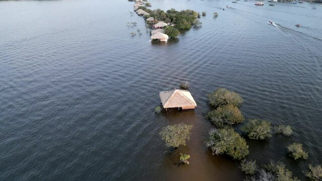 Aerial over the flooded buildings near Love Island (Ilha do Amor) during the rainy season in the State of Par&aacute;, Brazil. Drone dolly forward shot