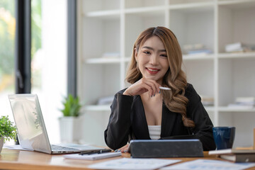 Young pretty asian businesswoman with laptop computer in the office.