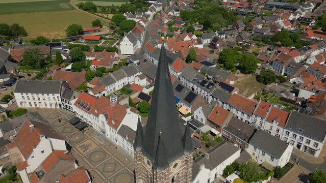 Parallax shot with drone of the Limburg Abbes Church, Wijngaard in thorn in the municipality of Maasgouw with a view of the Dutch architecture with historic buildings