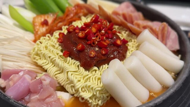 Budae jjigae is korean traditional food. anyway very famous international food. It is loaded with Kimchi, spam, sausages, ramen noodles, Korean hot pot food style. 