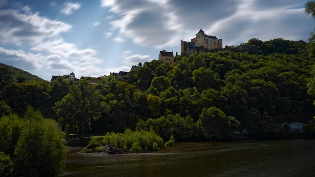 Timelapse of the magnificent castle of Castelnaud above the Dordogne river. with clouds that announce a storm, Dordogne, France
