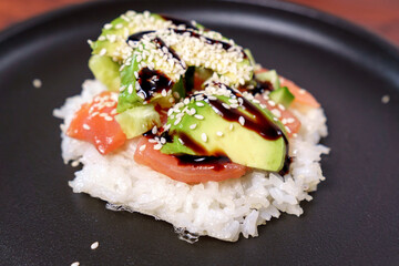 Sushi waffle is a cooking process. Culinary trend made with crispy rice waffles and sprinkled with salmon.