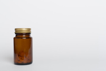 Plastic bottle for vitamins on color background