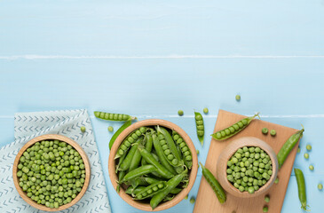 Composition with fresh green peas on wooden background, top view