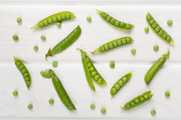 Composition with fresh green peas on wooden background, top view