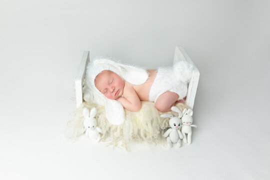 Cute newborn baby dressed up in a bunny costume. Easter. First photo session of a newborn