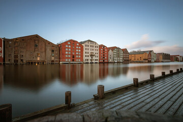 Obraz premium Long exposure of colorful historic timber storehouses in Trondheim, Norway in winter