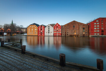 Long exposure of colorful historic timber storehouses in Trondheim, Norway in winter