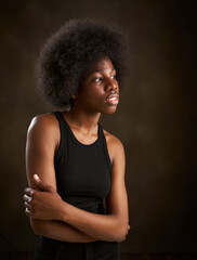 Young ethnic girl with afro hairstyle seen from the side