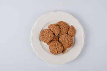 Chocolate chip cookies on a plate on a white background
