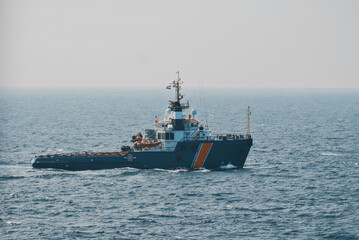 Coast guard vessel at sea. Vessel taking samples of the fuel emission. Guard vessel off the oil rig.