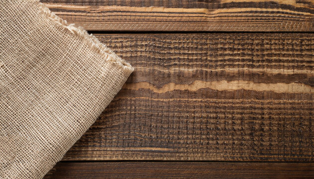 Burlap fabric cloth on brown wooden kitchen table with copy space