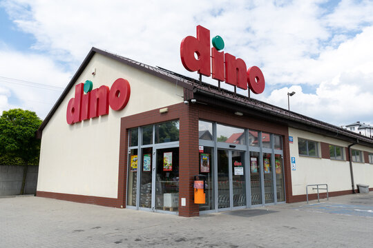 Dino supermarket shop with logo sign. Polish retail chain company, convenience grocery store in Poland. Signboard with brand logotype above entrance on June 18, 2023 in Mloszowa, Poland.