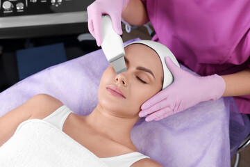 Young woman undergoing cosmetic procedure in beauty salon. Microcurrent therapy