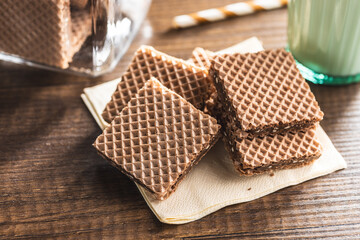 Sweet chocolate wafer on wooden table.