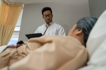 Doctors check patient outcomes in the recovery room after treatment.