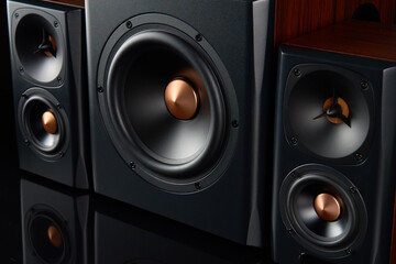 Multimedia acoustic sound speakers. Sound audio system with two satellites and subwoofer on dark...