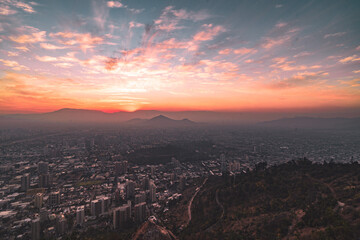 pink and orange sunset view over city of Santiago de chile from mountain San Cristobal