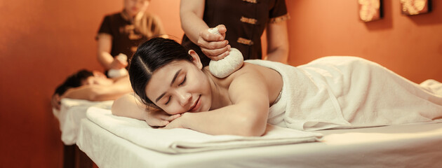 Relaxation Asian woman customer get service  Thai herbal compress massage in beauty spa centre. Body care.