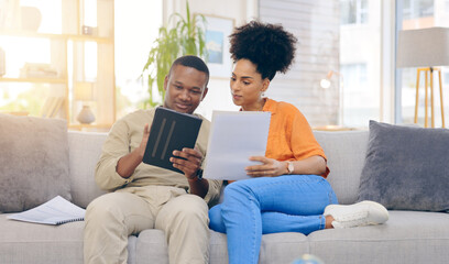 Fototapeta premium Tablet,documents, smile and couple on sofa in home living room, bonding and online shopping. Interracial, technology and happy black man and woman relax on social media, internet browsing or web scro