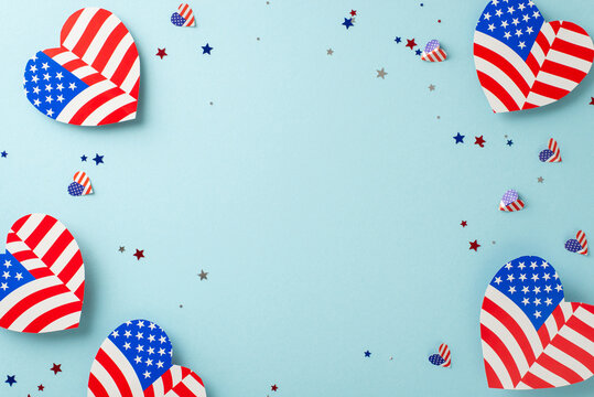 Commemorate Independence Day USA! Overhead shot of symbolic embellishments, hearts donning the American flag motif, sparkling confetti on a pastel blue surface with blank frame for text or promotions