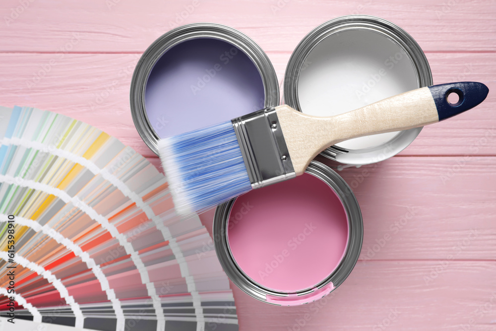 Poster Cans of pastel paints, palette and brush on pink wooden table, flat lay