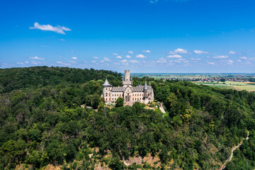 Fototapeta na wymiar German castle Marienburg, immersed in the greenery of the forest, not far from Hannover. Aerial view of a medieval, romantic castle.