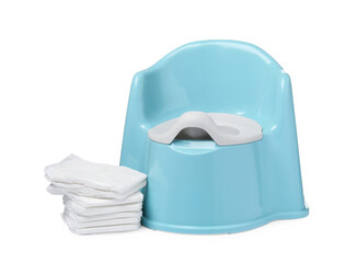 Light blue baby potty and stack of diapers isolated on white. Toilet training