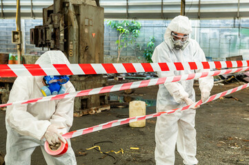 Man inspector scientist investigate chemical gas leak spill with safety face mask PPE suit in area...