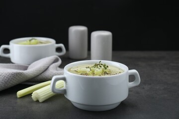 Bowl of delicious celery soup on gray table