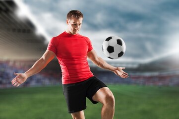 Running soccer player with a ball at stadium