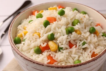 Delicious rice with vegetables in bowl, closeup