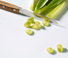 Frühlingszwiebeln geschnitten plus Messer mit Holzgriff