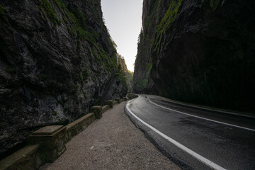 Amazing curved road between the mountains. Wide angle landscape photo with the road from Bicaz Gorges (Cheile Bicazului in Romanian language) landmark in Transylvania and Moldova.