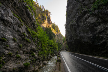 Amazing curved road between the mountains. Wide angle landscape photo with the road from Bicaz Gorges (Cheile Bicazului in Romanian language) landmark in Transylvania and Moldova.