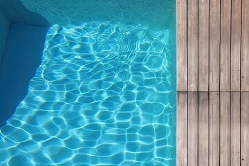 Poolside paradise. Top view of an empty outdoor pool with wooden board on beautiful relaxing background