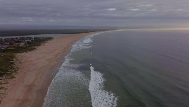South Africa drone aerial Jeffreys Bay surf town stunning early morning sunrise golden ocean surfer wave groundswell Sunrise sunset drone JBay stunning coastline beach cloudy cinematic circling motion