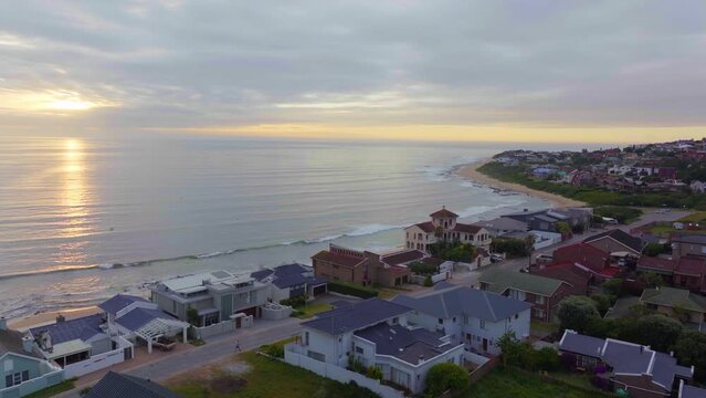 South Africa drone aerial Jeffreys Bay surf town stunning early morning sunrise golden sun on ocean surfer wave groundswell Sunrise sunset drone JBay bird fly coastline beach cinematic forward motion