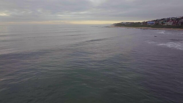 South Africa drone aerial Jeffreys Bay surf town stunning early morning sunrise golden sun on ocean surfer wave groundswell Sunrise sunset drone JBay stunning coastline beach cinematic forward motion