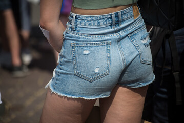 Obraz na płótnie Canvas Closeup of mini jeans short on woman in the street