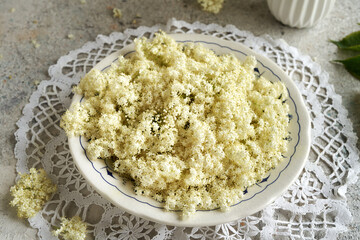 Elderberry flowers in a plate on a table
