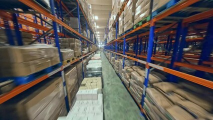 FPV Flight Between The Racks With Boxes Inside The Merchandise Warehouse. - aerial