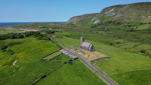 An old Irish christian church nestled in a quiet valley of Donegal, Ireland.  A graveyard and car park surrounding. A very remote part of Ireland