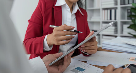 Businesspeople analyzing investment graph meeting brainstorming and discussing plan in meeting room at office, investment concept