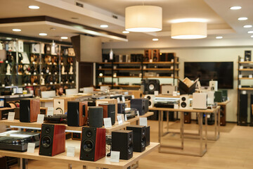 Background image of speakers and music equipment on display in music store, copy space